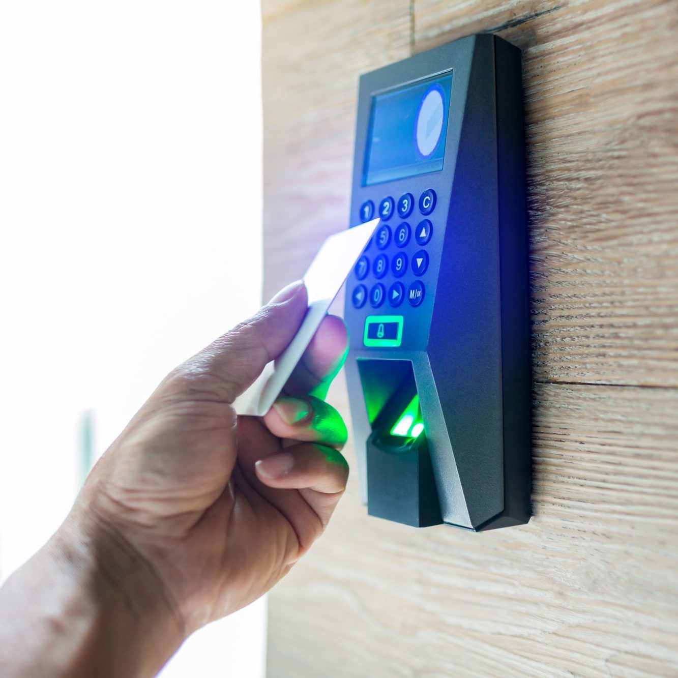 Door access control. Staff holding a key card to lock and unlock door at home or condominium. using electronic card key for access. electronic key and finger scan access control system to unlock doors