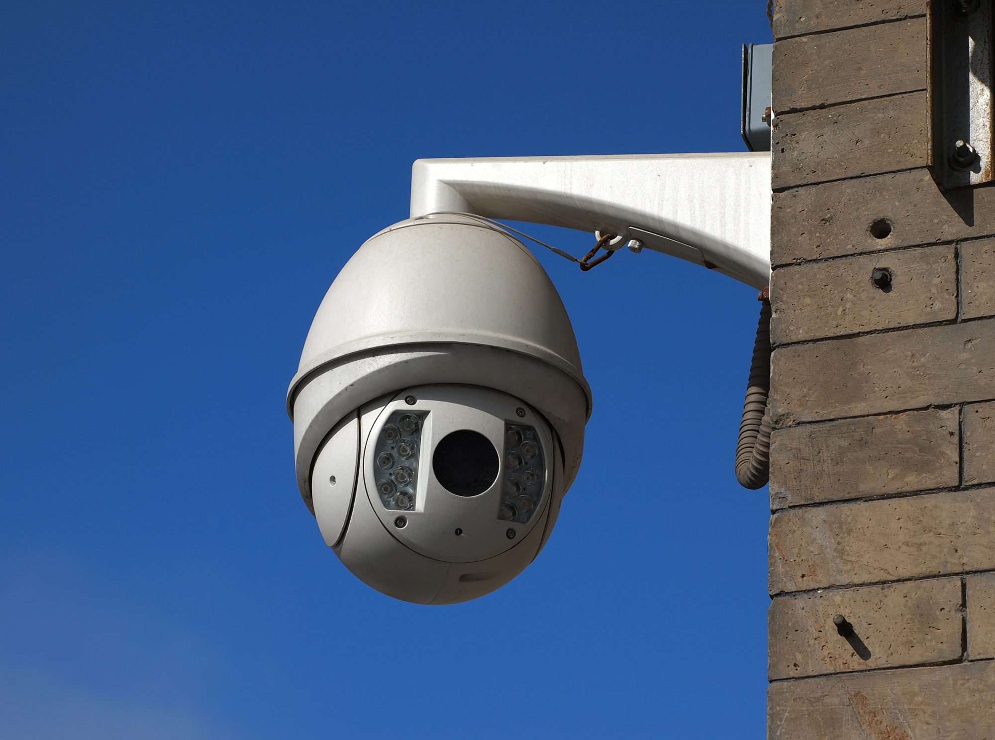 Cctv camera over blue sky.